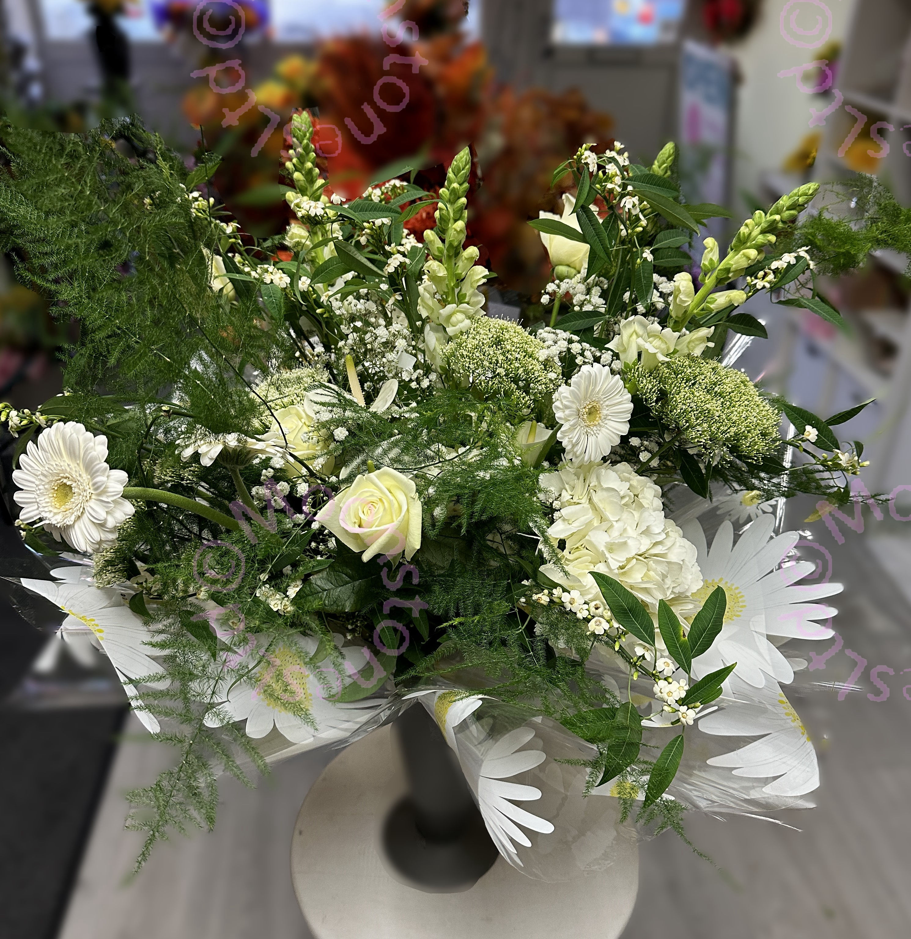 A tied bouquet of all mixed white flowers by fareham florist